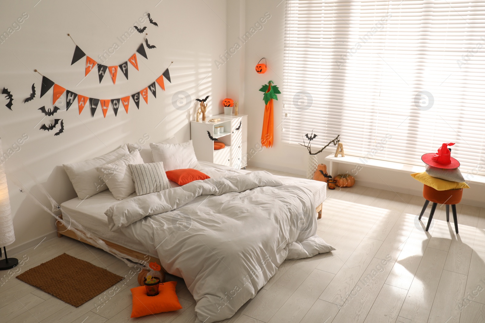 Photo of Stylish bedroom interior with festive Halloween decor