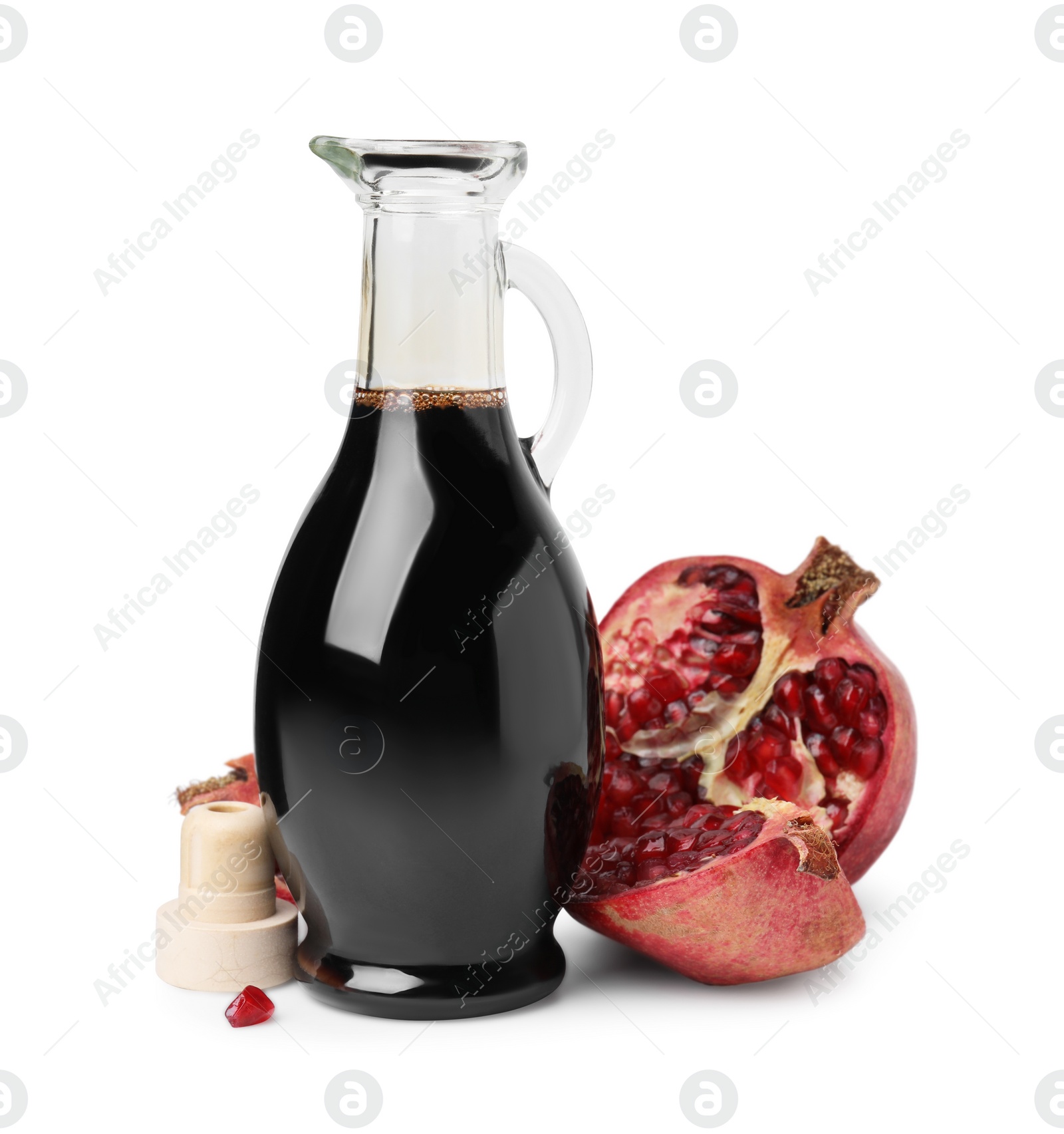 Photo of Tasty pomegranate sauce in bottle and fruits isolated on white