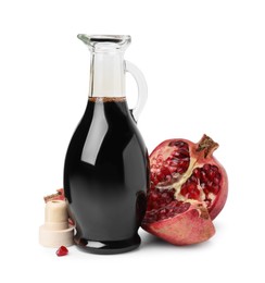 Photo of Tasty pomegranate sauce in bottle and fruits isolated on white