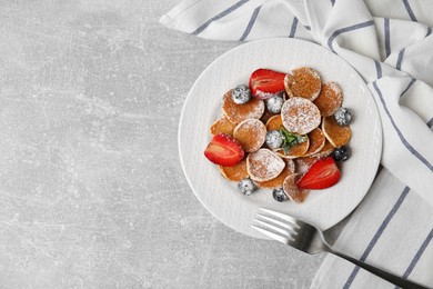 Photo of Cereal pancakes with berries served on light grey table, flat lay. Space for text