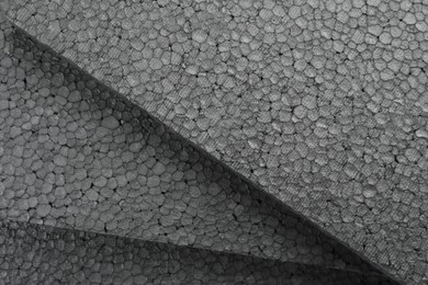 Many grey styrofoam sheets as background, closeup