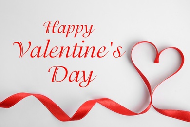 Image of Happy Valentine's Day. Heart made of red ribbon on white background, top view 