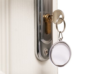 Photo of Key with fob in door lock, closeup. Space for text