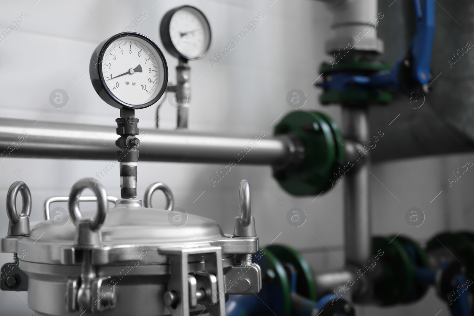 Photo of Pressure gauges and pipes indoors, space for text. Production machinery at modern granary