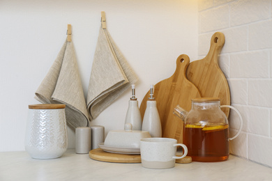 Photo of Wooden boards, napkin and kitchen items on countertop indoors