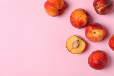 Sweet juicy peaches on pink background, top view. Space for text