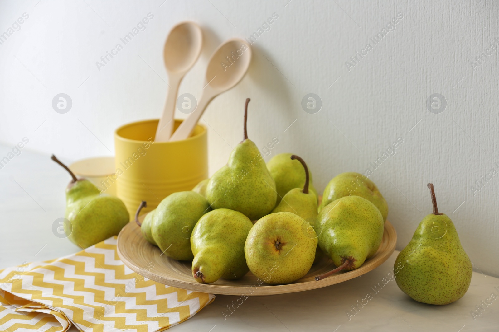 Photo of Plate with fresh ripe pears on white table