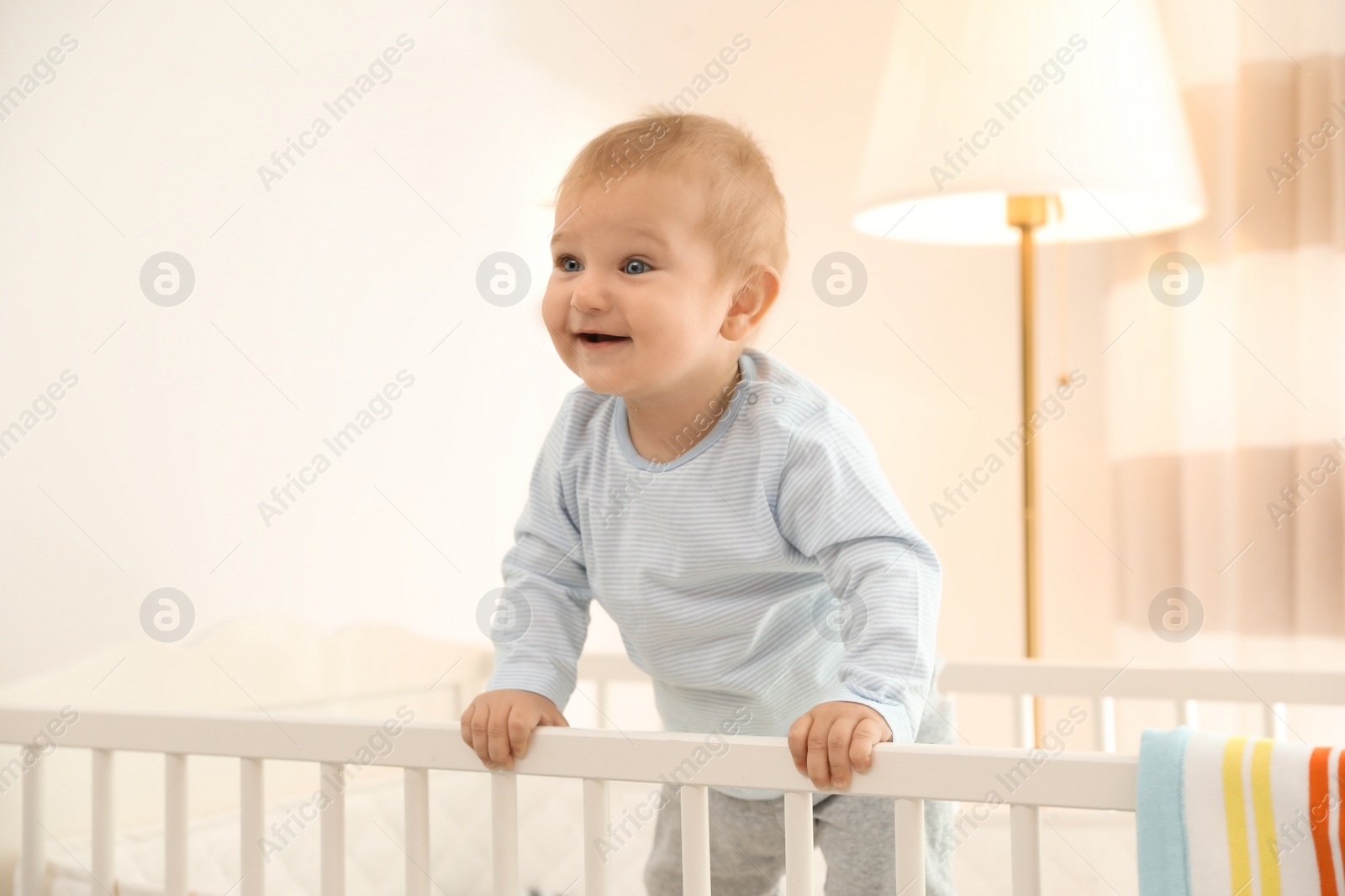 Photo of Cute little baby in crib at home