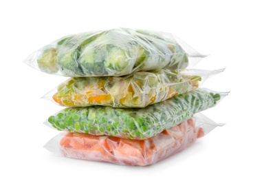 Photo of Plastic bags with frozen vegetables on white background