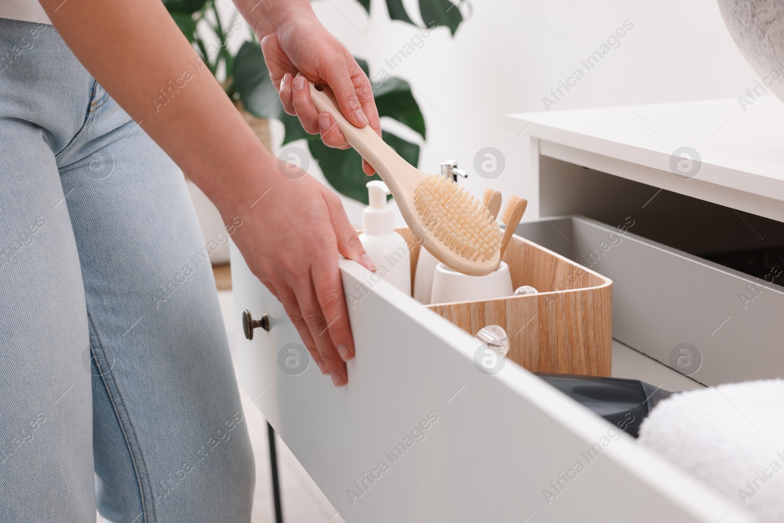 Photo of Bath accessories. Woman organizing personal care products indoors, closeup