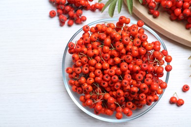 Photo of Fresh ripe rowan berries on white wooden table, flat lay. Space for text