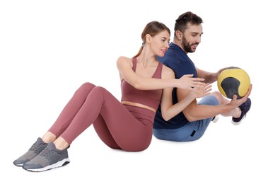 Photo of Athletic couple doing exercise with medicine ball on white background