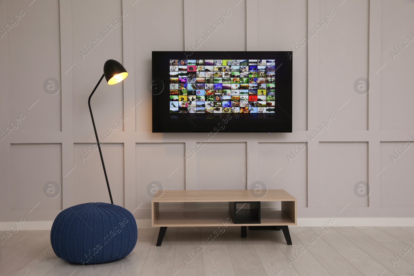 Photo of Modern TV on white wall in room