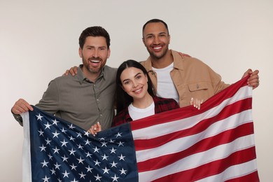 4th of July - Independence Day of USA. Happy friends with American flag on white background