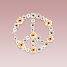 Hippie peace symbol made of beautiful flowers on dusty pink background