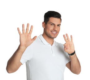 Man showing number eight with his hands on white background