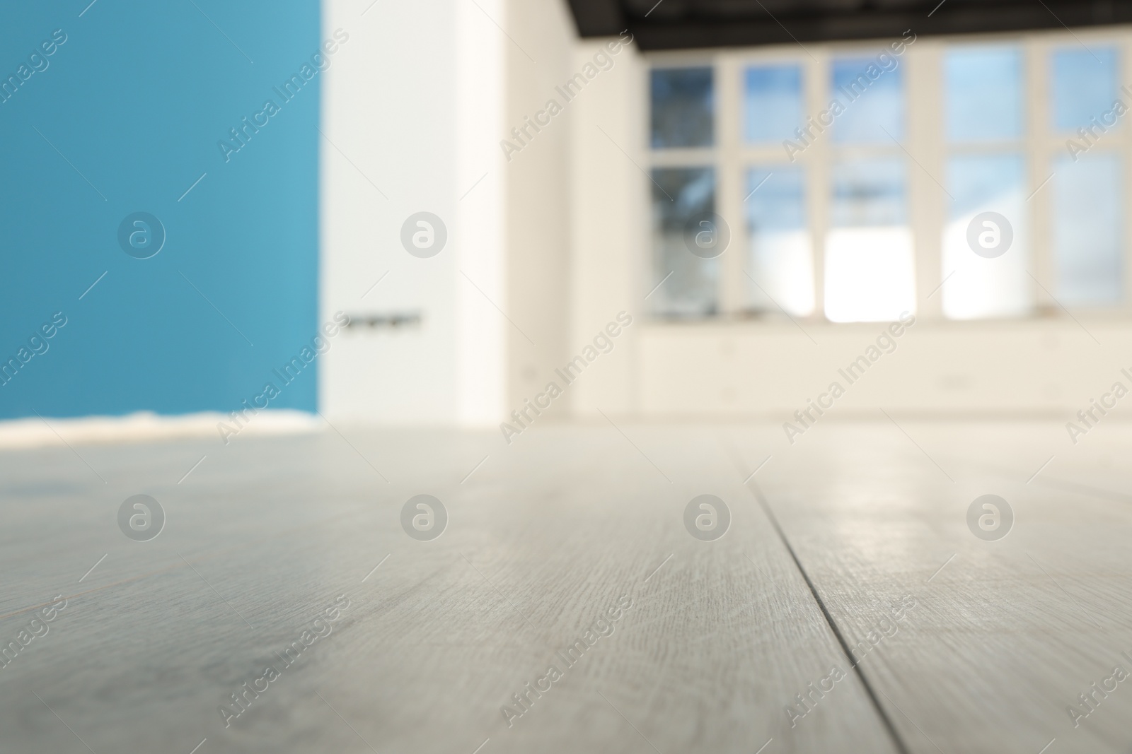 Photo of Empty room with new white laminated flooring, closeup