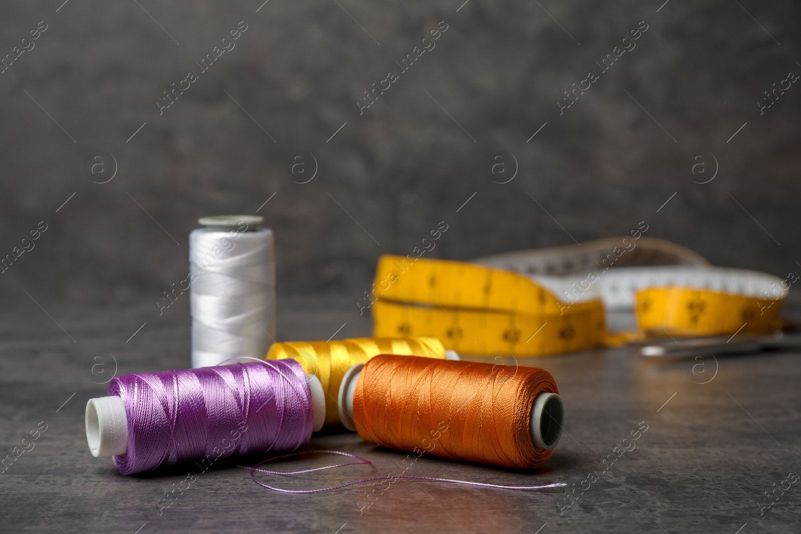 Photo of Color sewing threads on gray background