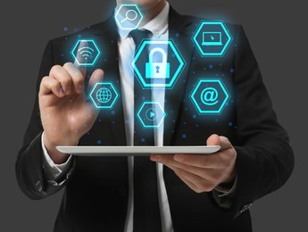 Image of Cyber security concept. Closeup view of man with tablet and different virtual icons on grey background, illustration