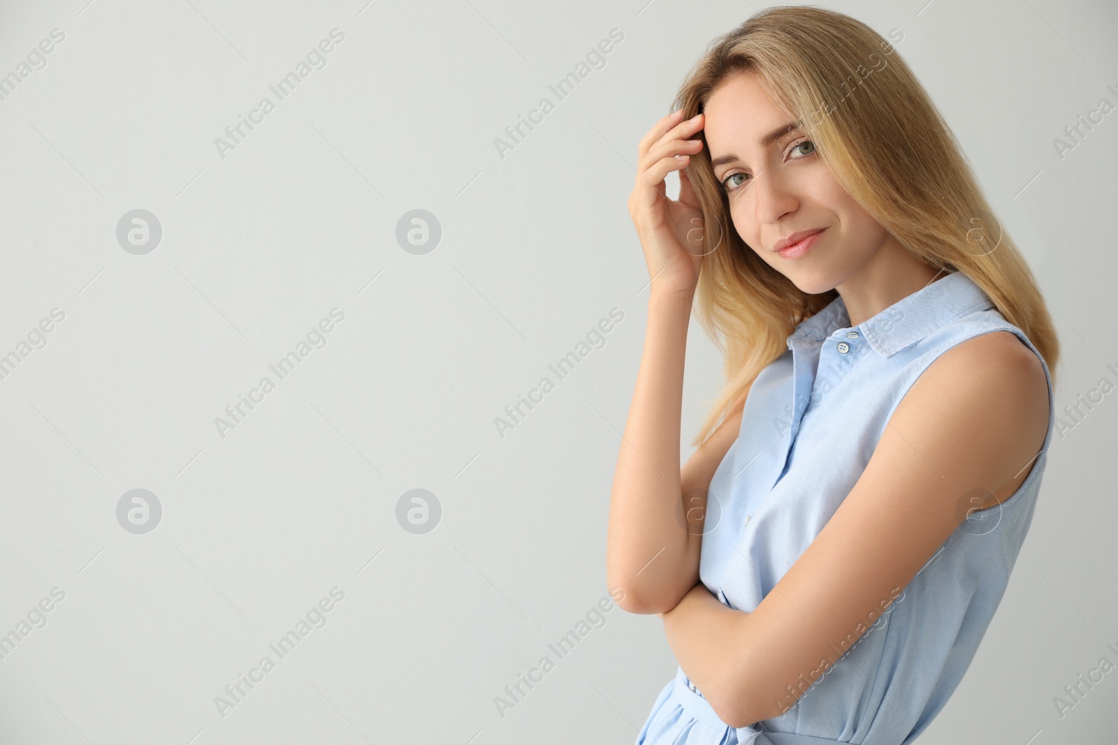 Photo of Portrait of beautiful young woman on light background. Space for text