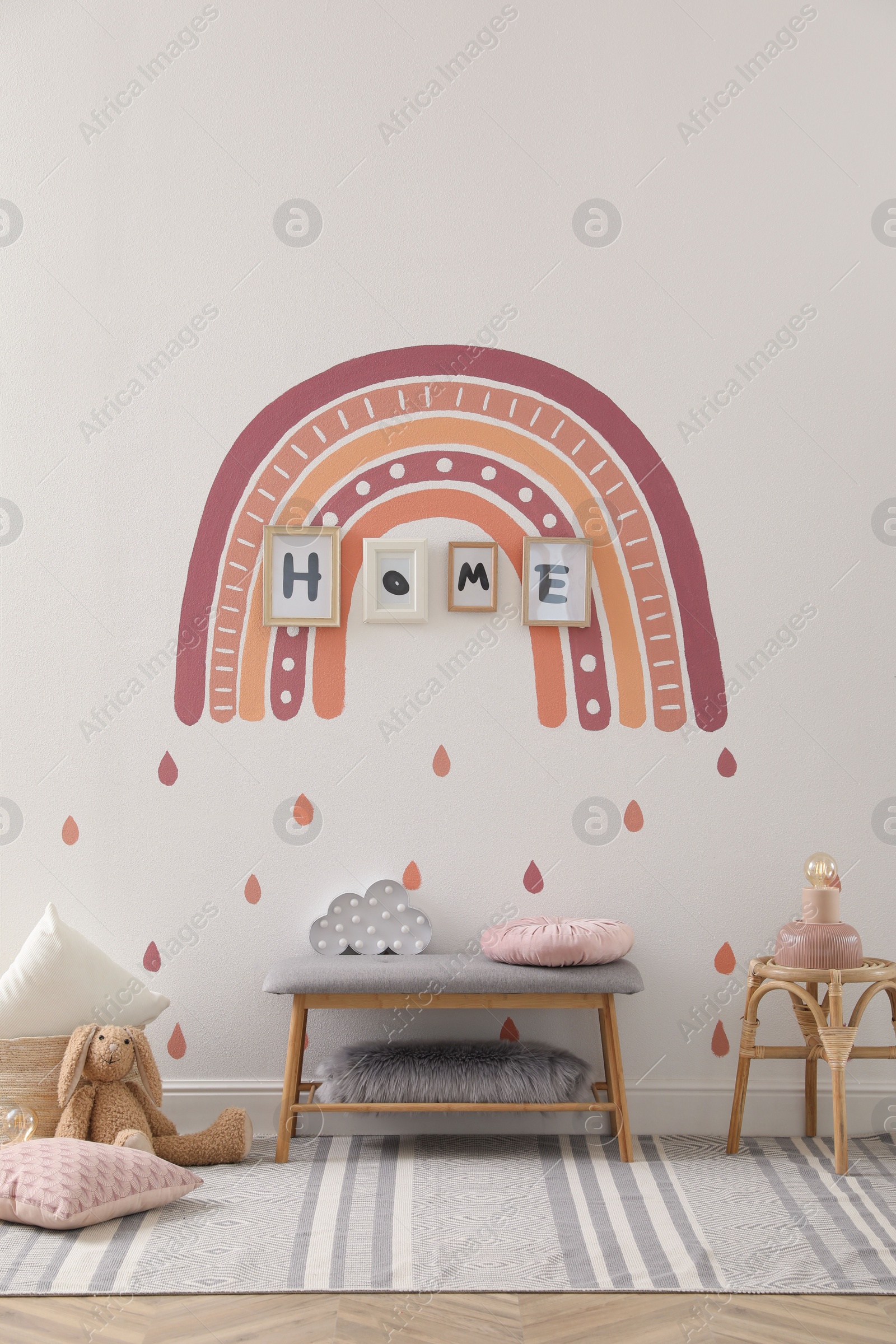 Photo of Child's room interior with rainbow painting on wall