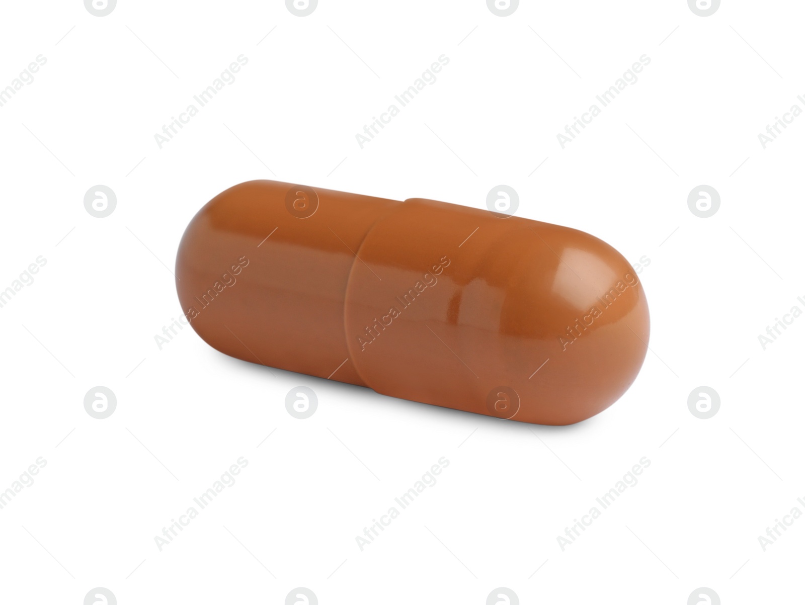 Photo of One brown pill on white background. Medicinal treatment