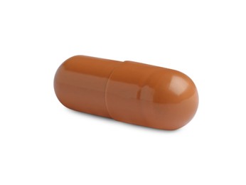 Photo of One brown pill on white background. Medicinal treatment