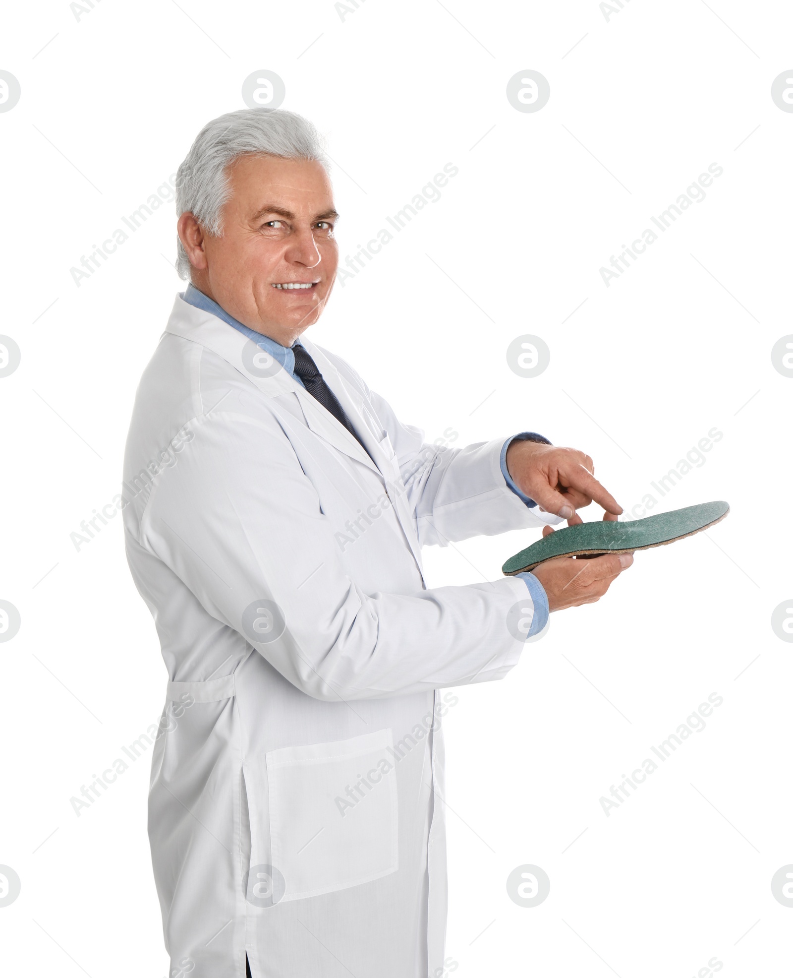 Photo of Male orthopedist showing insole on white background