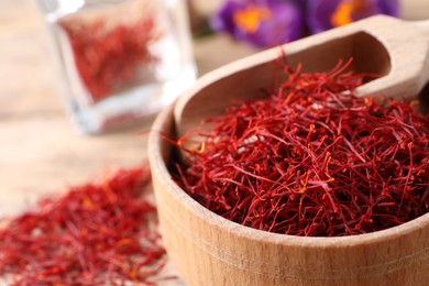 Photo of Dried saffron and crocus flowers on table, closeup. Space for text