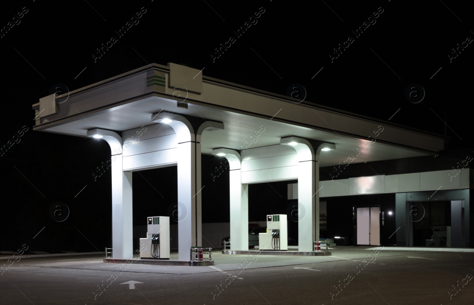 Photo of Modern gas station with convenience store beside the road at night