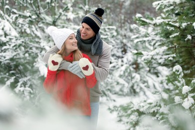 Photo of Beautiful happy couple in snowy forest on winter day