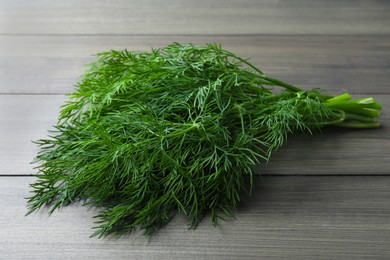 Photo of Bunch of fresh dill on wooden table
