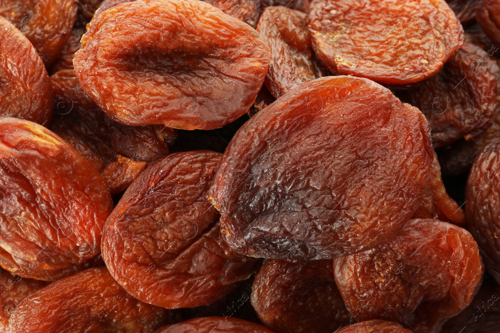 Photo of Tasty dried apricots as background, top view