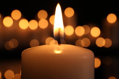 Burning candle in darkness, closeup. Memory day