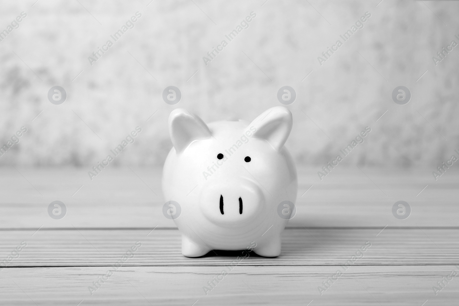 Photo of Ceramic piggy bank on white wooden table, space for text. Financial savings