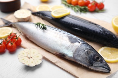 Photo of Tasty raw mackerel and ingredients on white textured table, closeup