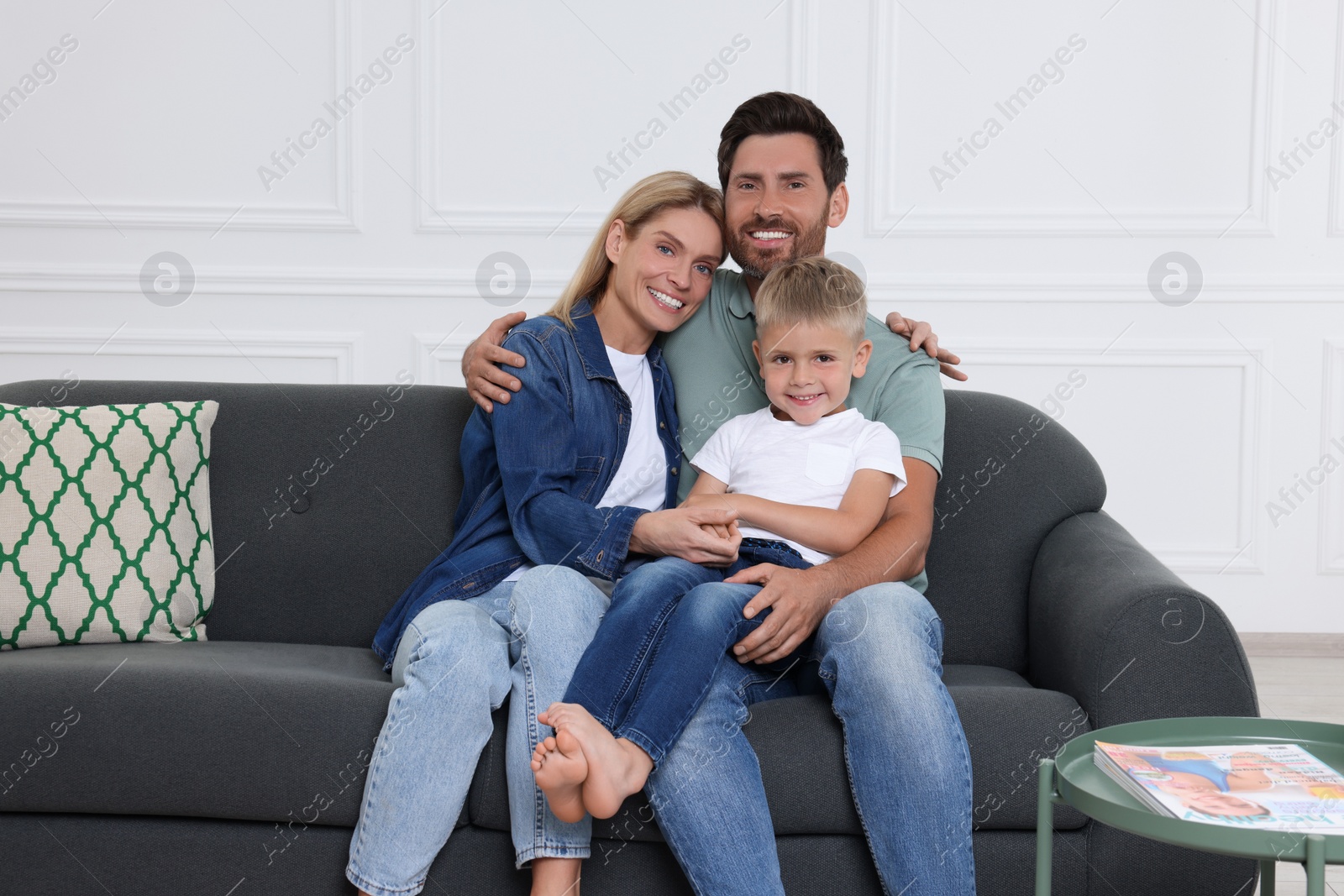 Photo of Portrait of happy family with child on sofa at home