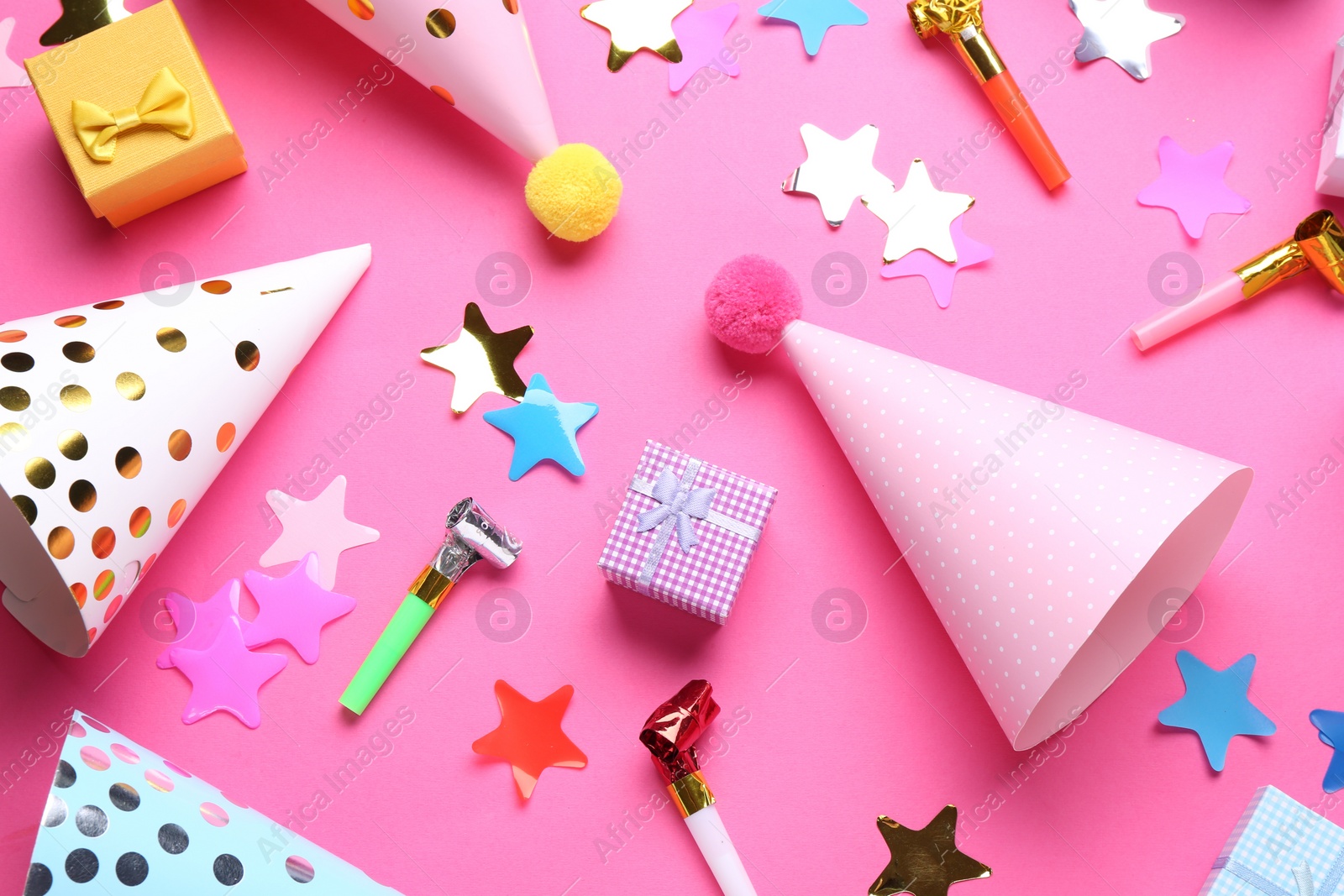 Photo of Flat lay composition with party hats on pink background