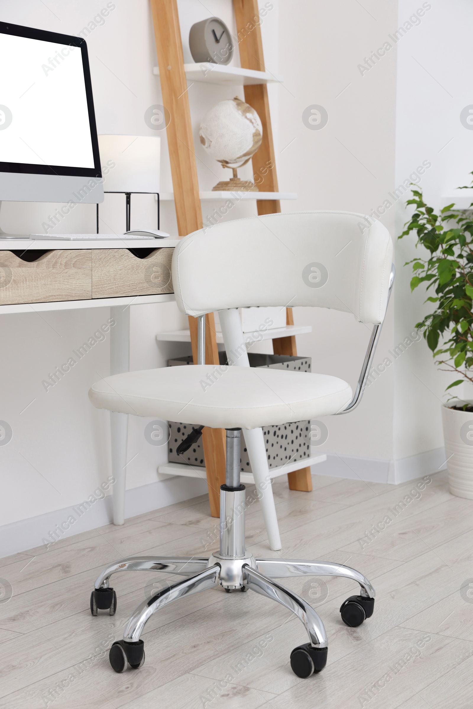 Photo of Workplace with comfortable office chair indoors. Interior design