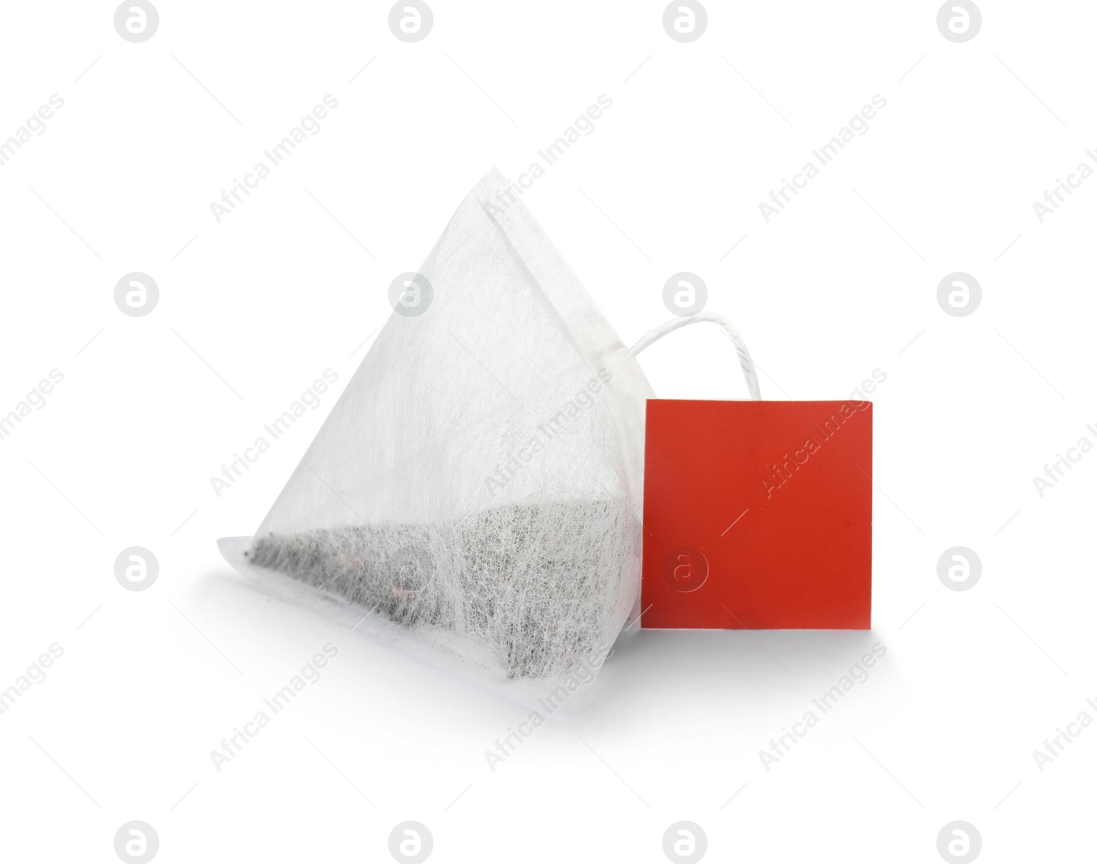 Photo of Unused pyramid tea bag with tag on white background. Space for text