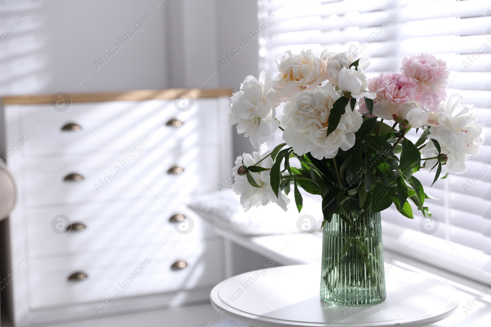 Photo of Bouquet of beautiful peony flowers on table indoors. Space for text