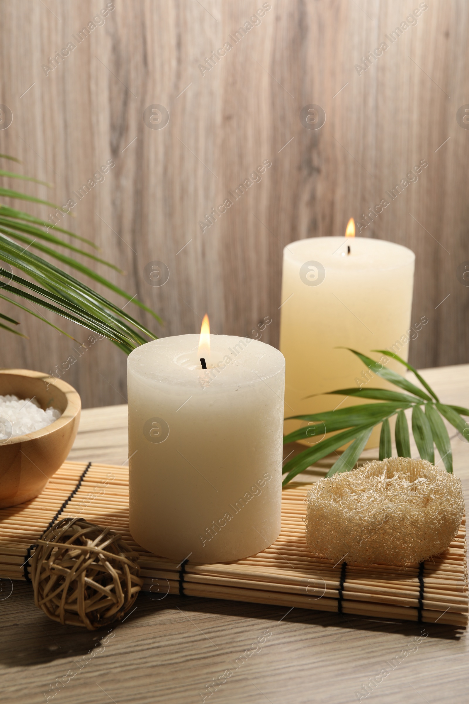 Photo of Composition with spa supplies and palm leaves on wooden table