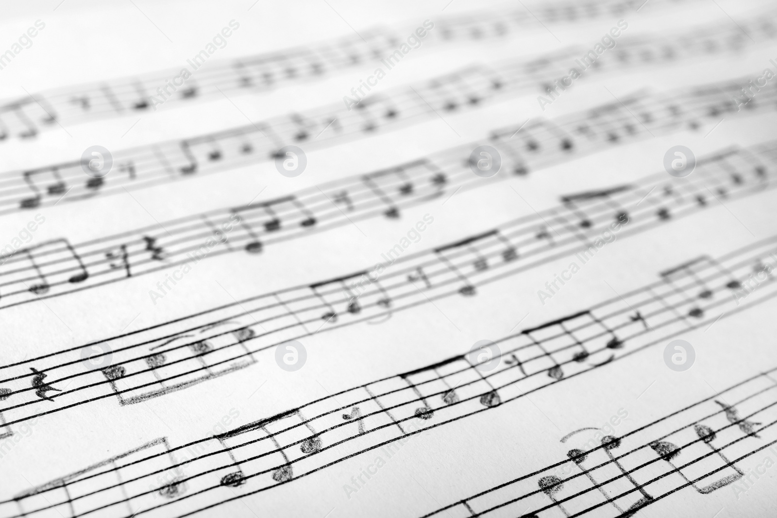 Photo of Sheet with music notes as background, closeup