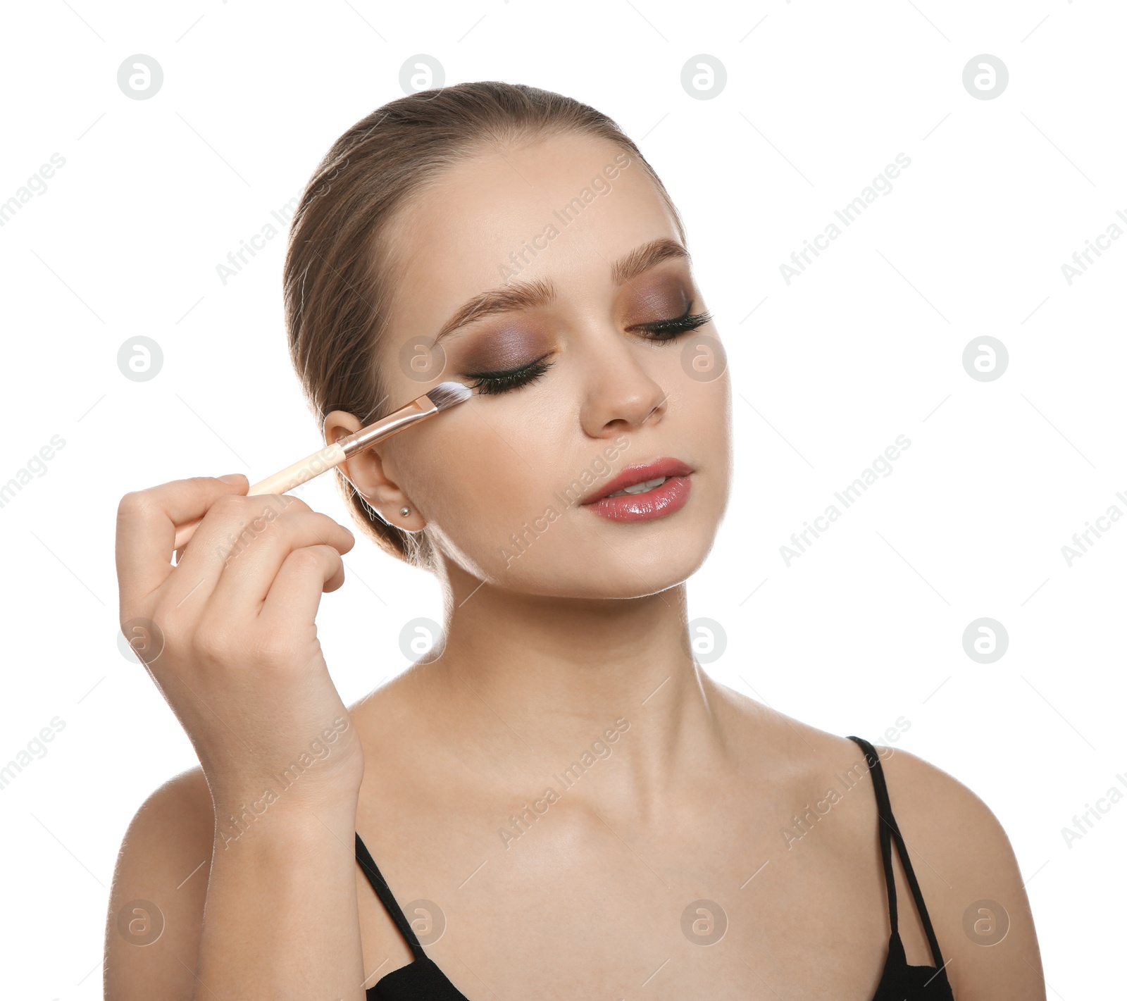 Photo of Beautiful woman applying makeup with brush on white background