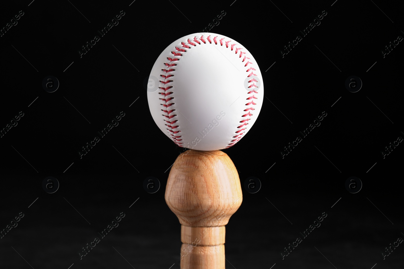 Photo of Baseball bat and ball on black background. Sports equipment