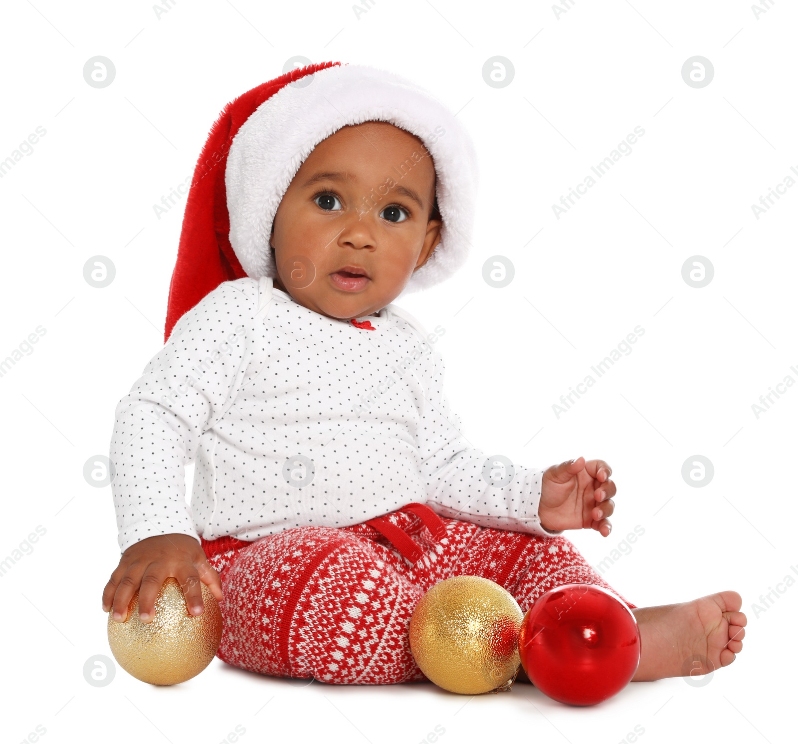 Photo of Festively dressed African-American baby with Christmas decorations on white background