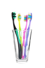 Photo of Cup with different toothbrushes on white background. Dental care