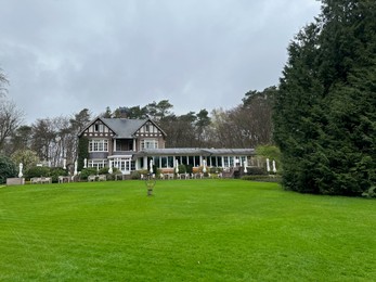 Luxury hotel, garden and green trees outdoors