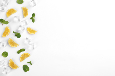 Photo of Lemonade layout with lemon slices, mint and ice cubes on white background, top view