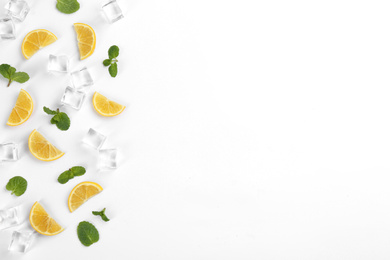 Lemonade layout with lemon slices, mint and ice cubes on white background, top view